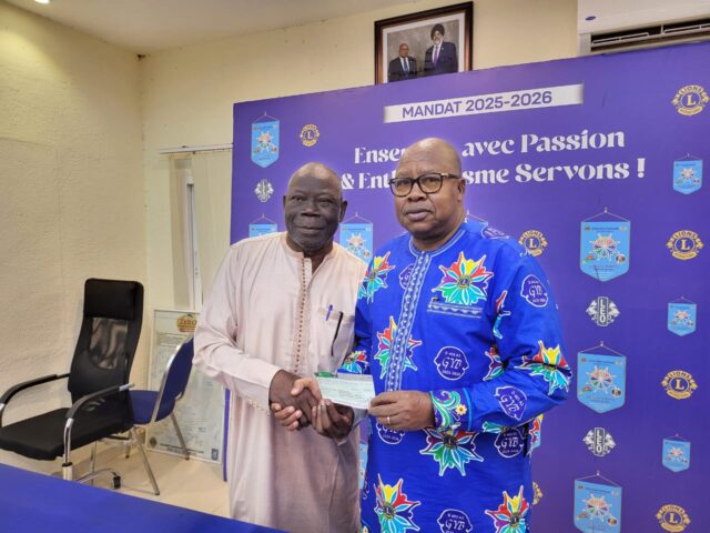 Le Gouverneur du District 403 A3, Yacouba Barry remettant le cheque au président de l'ABUDIR, le professeur Albert Ouédraogo