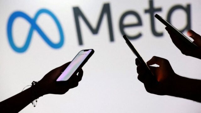 FILE PHOTO: Illustration shows teenagers pose for a photo while holding smartphones in front of a Meta logo